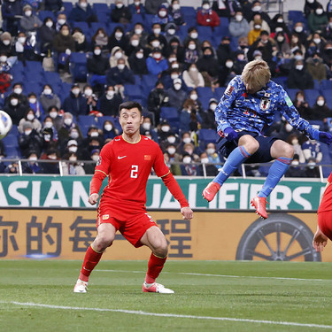 Football: Japan-China World Cup qualifier Junya Ito (C) scores Japan s second goal with a header during the second half